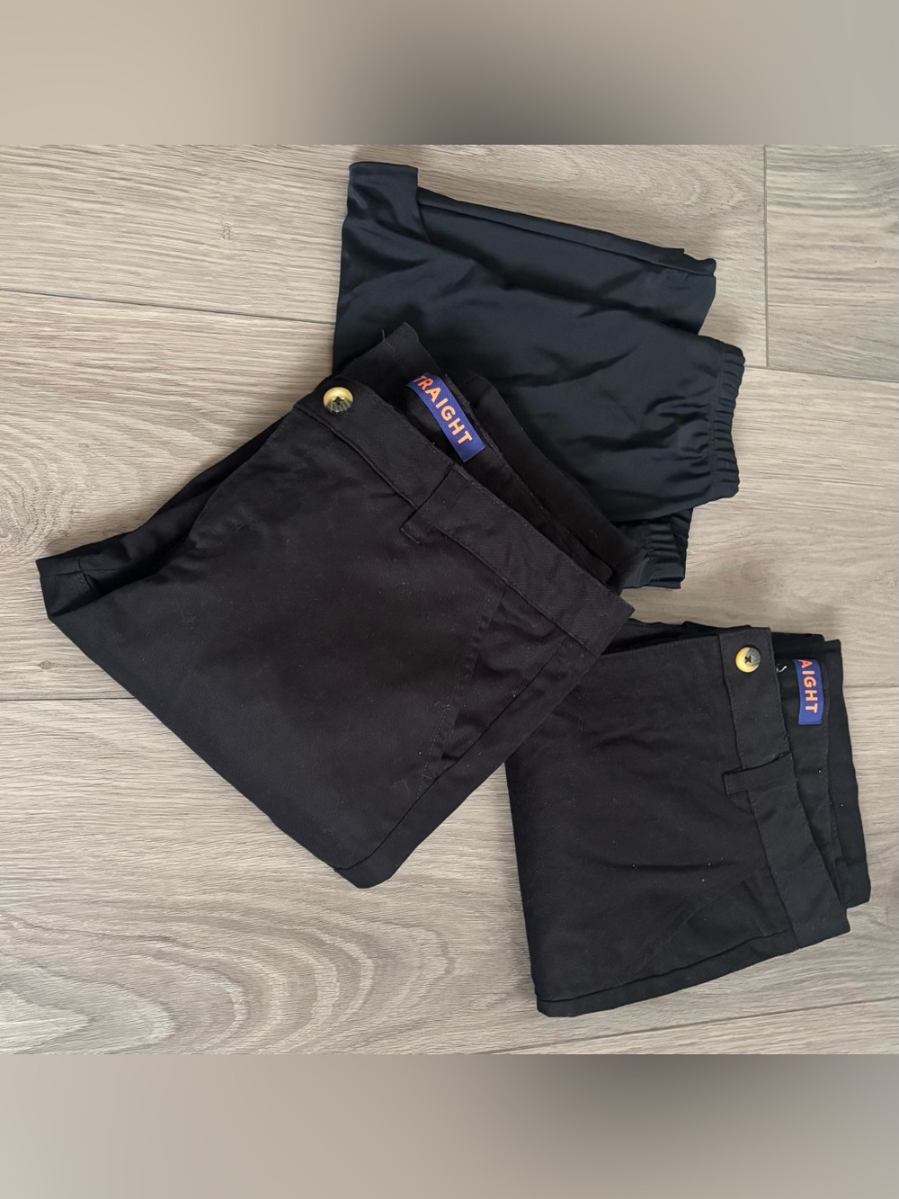 2 French Connection Kids Black School pants and black leggings.